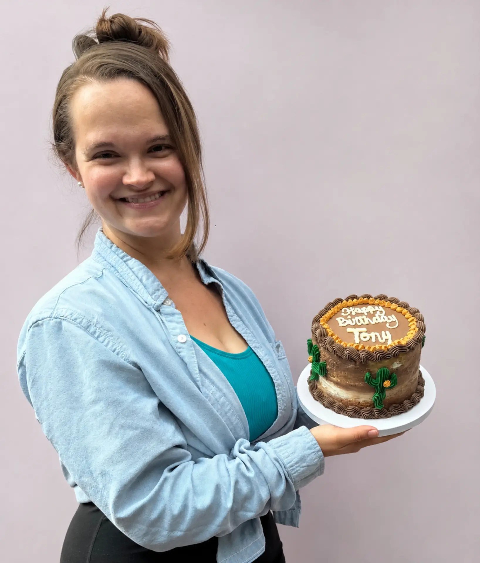 Krista Morgan holding a handcrafted cake