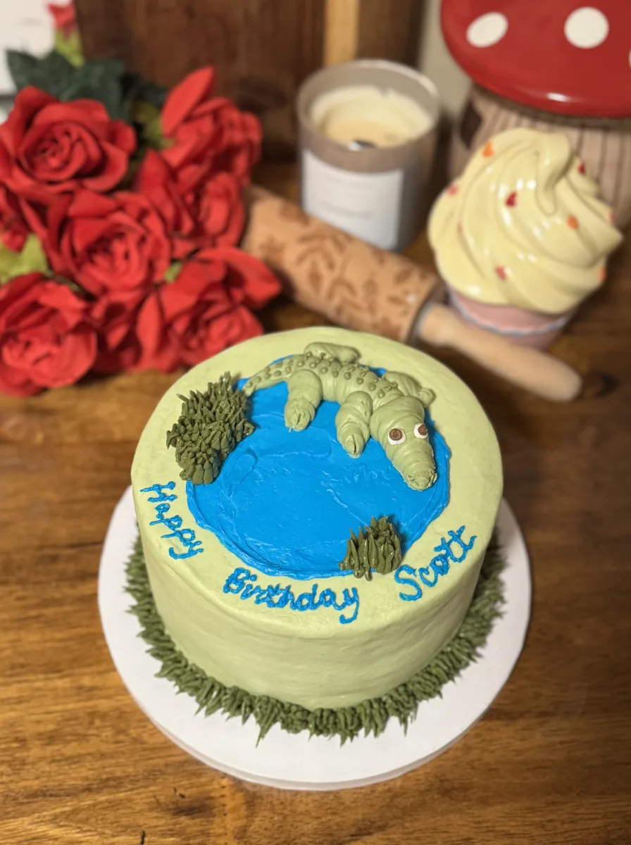 A handcrafted birthday cake with a blue pond design